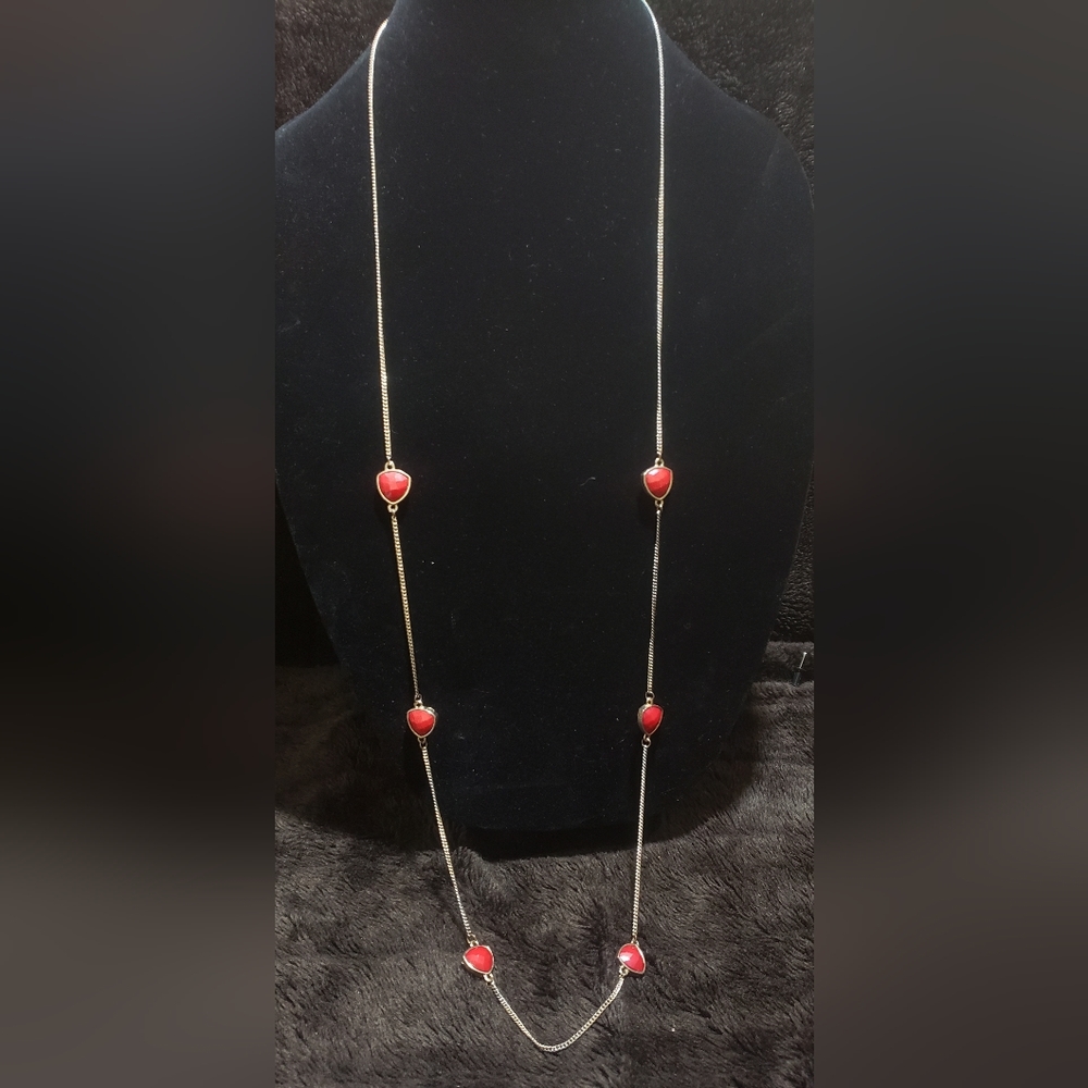 long gold tone necklace with red tone acrylic stones
